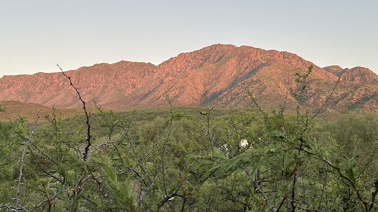 Sunsets make Uritorco appear pink